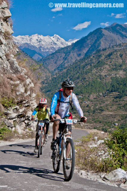 Fifth Day of MTB Himachal 2010 - Highest peaks of Jalori Pass welcomed us with Snowfall - 27th October 2010: Posted by VJ SHARMA on www.travellingcamera.com : Hope you have been enjoying the PHOTO JOURNEY of MTB Himachal 2010 and it's fifth day now ... Everyone has left Kullu Sarahan Camp and first stretch has started .... ON fifth day we had to reach Baahu for camping... We crossed Baghipul, Urtu, Nithar, Bandal, Kutal, Kalog, Durah, Nithar, Jalori and finally reached Bahu... Check out these photographs from fifth day of Bike Riding....Mr. Ankit Sood and Sumit Sond, two PHOTOQUEST participants .... Both of them were very energetic and  on fifth day of MTB Himachal, they decided to have Buggy ride... I had a good company with Ankit, Sumit, Surbhit and Jimsee... Real Artists !!! Riders moving towards Jalori Pass which had recently got snowfall... everyone excited to hit the place with snow and have some fun in white...Real Engineers of India who make our lives comfortable... Here is a Photograph of daily-wage worker on th side of a road under harsh sun.. He is breaking big stones into appropriate sized pieces for repairing the adjacent road...During fifth day, we were traveling on very high and narrow roads ...  Here is one of the view we had from the edge of a road ...  A Photograph of Satluj River crossing various hurdles of Himalayas...Finally whole Group of MTB Himachal riders reached Jalori Pass... here is the beginning of the mountains with snow... Most of the mountains at Jalori Pass had recently got snowfall and Bangar hills were just behind these hills....I also wanted to have one photograph with these riders in front of Bangaar Hills but unfortunately snow covered Bangaar Hills are not clear in this Photograph...This is the point where we had to start the uphill Stretch and we are standing here to make sure that every rider take the hidden cut rather than going straight towards Aanni... Most of the Photographers were asked to stop at tis point because the road ahead was narrow and we didn't want to block the road for riders....Since we were waiting at this point, I though to trying some panning shots here and here is one of the panning shot of rider flying towards Baahu...This journey was wonderful journey through scenic roads with naturally rich hills in Himalayan Ranges of Himachal .. Really MTB Himachal 2010 provided a great opportunity to explore unexplored Himalayan beauty...Here is a photograph of a Himachali Village which came on the way to Baahu...Seeing waterfalls, snow covered hills, beautiful houses was a common thing during this journey of MTB Himalayas ... Its evening time now and time to take rest at Baahu Camp.... 