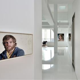 Portraits on the white penthouse walls 