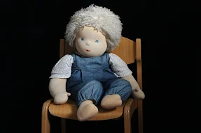doll sitting on a chair