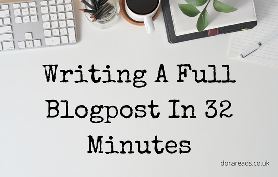 'Writing A Full Blogpost In 32 Minutes' with a stereotypical blogger-desk (computer keyboard, coffee cup, pot plant, stationary) in the background