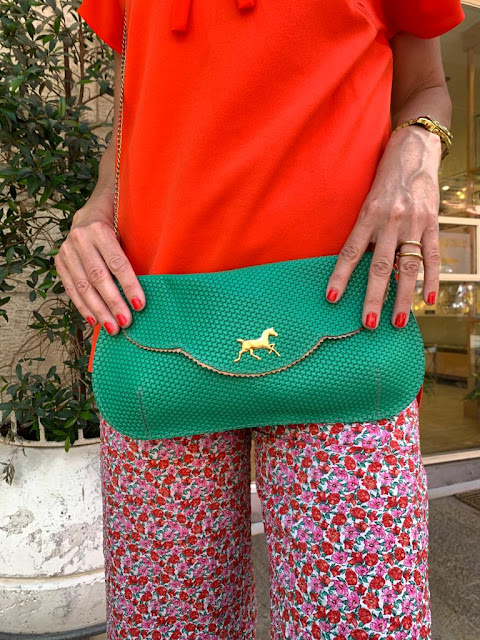 green clutch with bronze horse