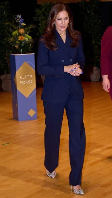 The Fold Alzira navy straight flared trousers. Queen Mary wore a navy wool Abbeville jacket by The Fold. Gianvito Rossi pumps