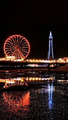 Pemandangan pantai malam hari yang aesthetic dengan taman hiburan