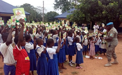 Cross River Commandant of the Peace Corps of Nigeria,  Patriot Okweche Dominic Distributing The Books to The Pupils At St. Dominic Primary School Ibiaragidi-Iye in Ibiaragid,  Bekwerra local government area of 