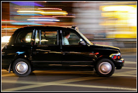 Black London cab in the street at night 