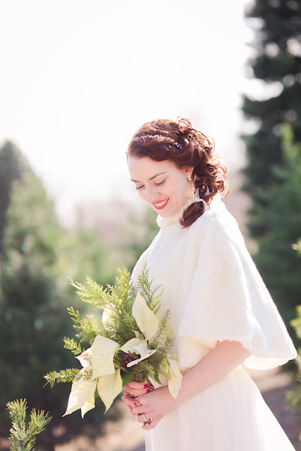 Marissa makes a stunning winter bride.  Shot at a local tree farm in Tuttle, OK, she was surrounded by evergreen trees of all sizes, making her backdrop festive and unique.  Along with her Christmas themed wedding, she is holding a white poinsettia and evergreen bouqet.