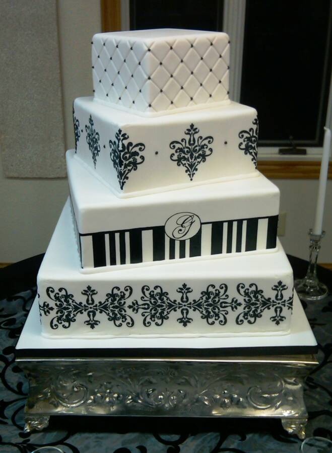 Lovely four tier black and white damask wedding cake with green satin ribbon