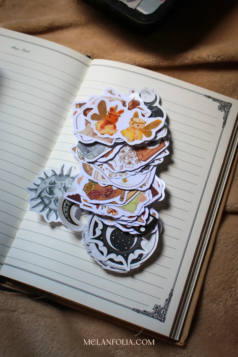 different cute stickers on top of a journal