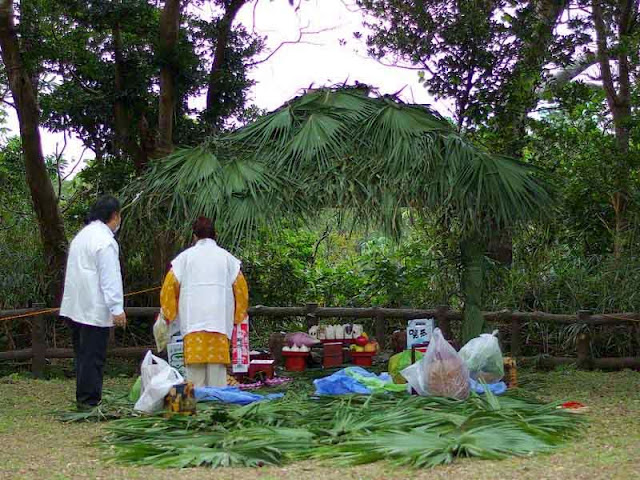 straw-roofed hut and preparations for blessings