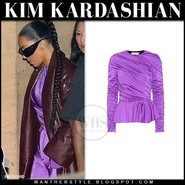 Kim Kardashian in brown coat, purple top and purple pants