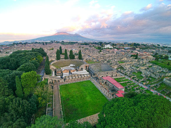 Pompeii's theaters as seen from above by a drone, with Vesuvius in the backdrop. ElfQrin / CC BY-SA 4.0 / ElfQrin / CC BY-SA 4.0 / ElfQrin / CC BY