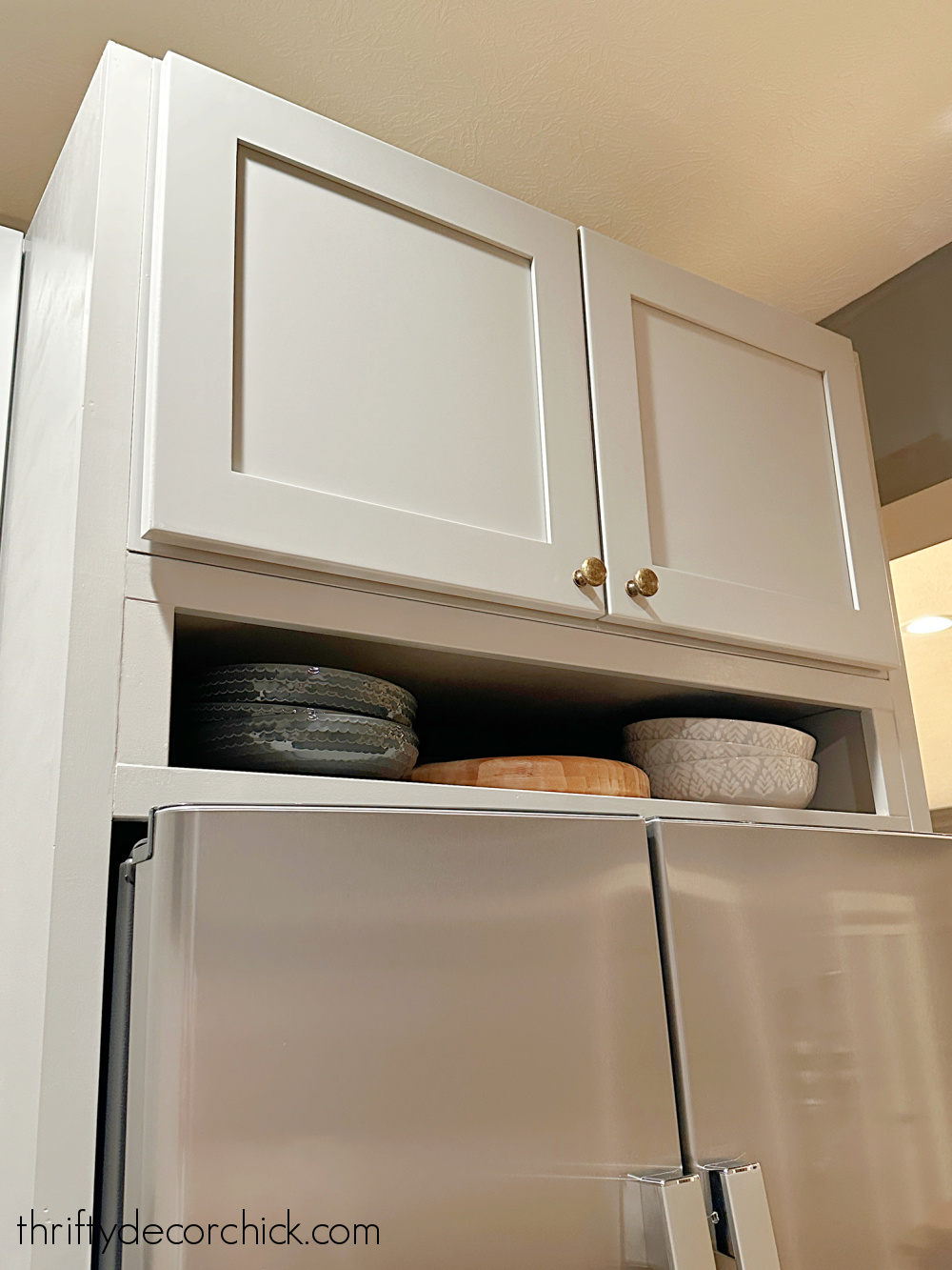 small shelf above refrigerator