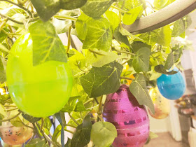 Take your Easter Egg hunt inside with this fun Easter decoration. It's so easy to decorate your dinning room chandelier with beautiful Easter eggs and greenery to make a stunning Easter Egg Chandelier that will bring some extra sparkle and shine to your Easter dinner.