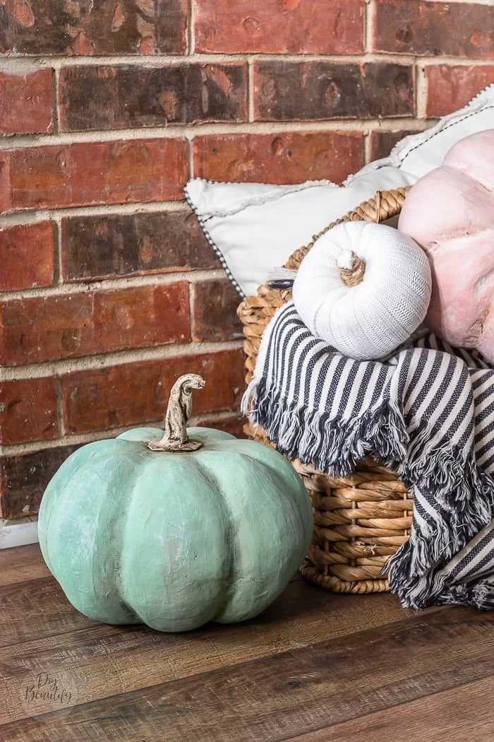 brick wall, farmhouse floors and basket full of DIY heirloom Cinderella pumpkins