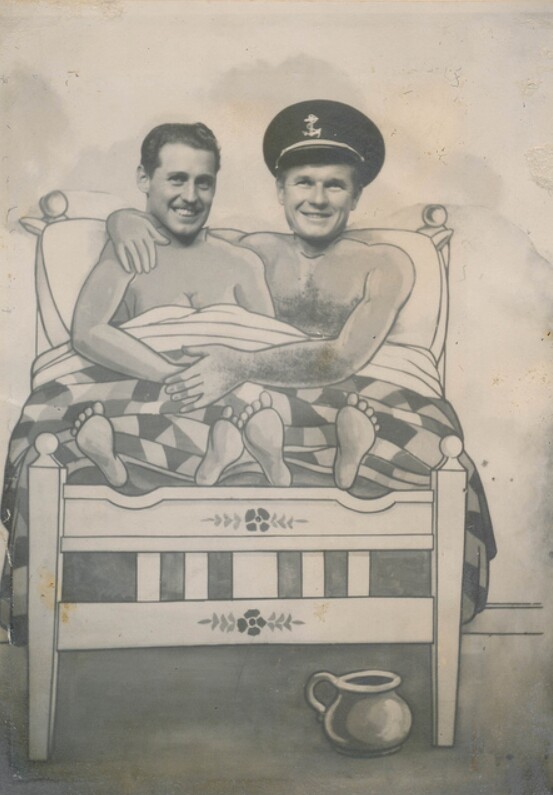 Two men pose in a carnival cutout