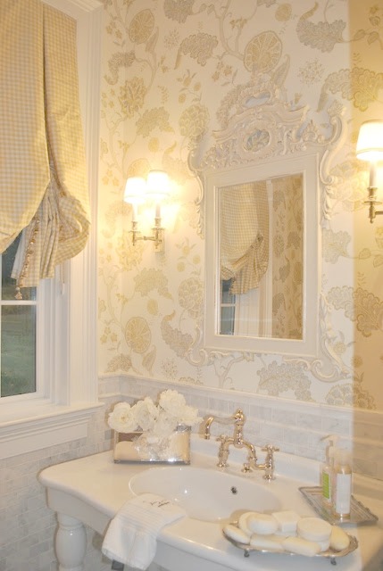 Exquisite elegant wallcovering and sconces in luxurious powder room by Enchanted Home