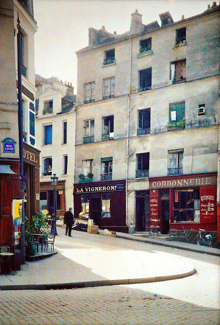 Old photo of Paris with cobbled street and old shops