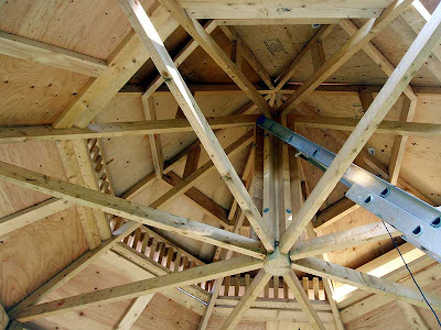 Now that the roof is overhead he can install the spindles even on rainy days.