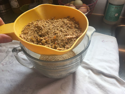 winnowing quinoa with a strainer