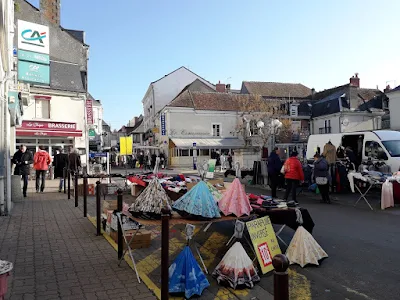 Colourful umbrellas on sale at Descartes market in November 