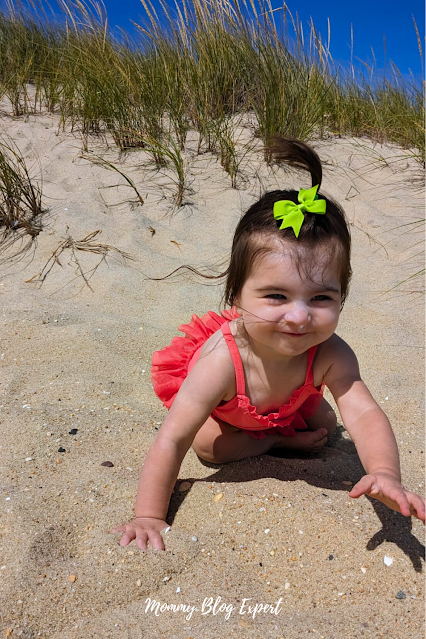 Little Girl Playing on Sand at Beach