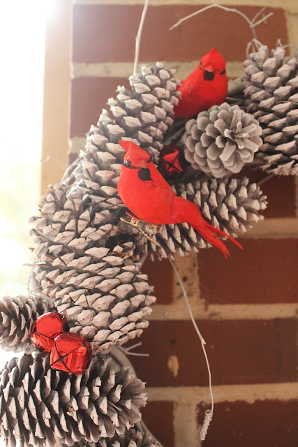 red bird and white pinecone wreath