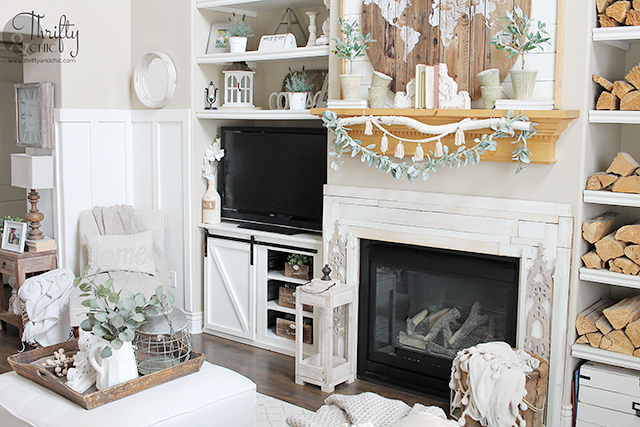 Farmhouse spring living room decor and decorating ideas. Living room inspo. Living room inspiration. White and wood living room. Spring mantel decor. spring mantle decorating ideas. Boho style living room. 