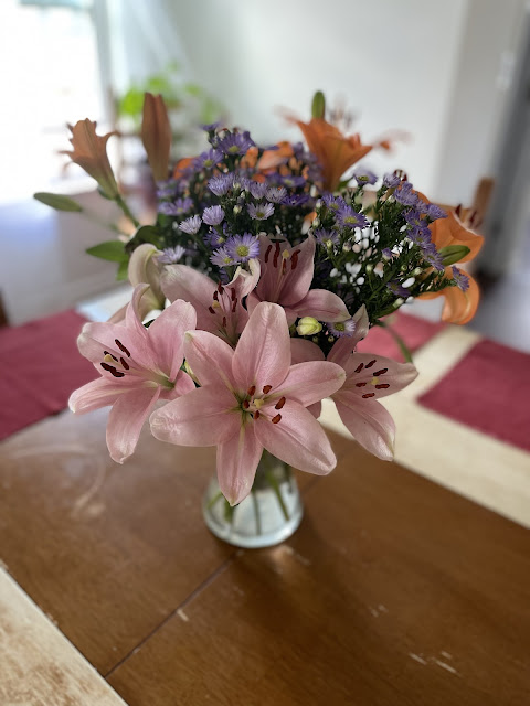 Another view of the flower arrangement on the dining room table - this one is focusing on the light pink lilies.
