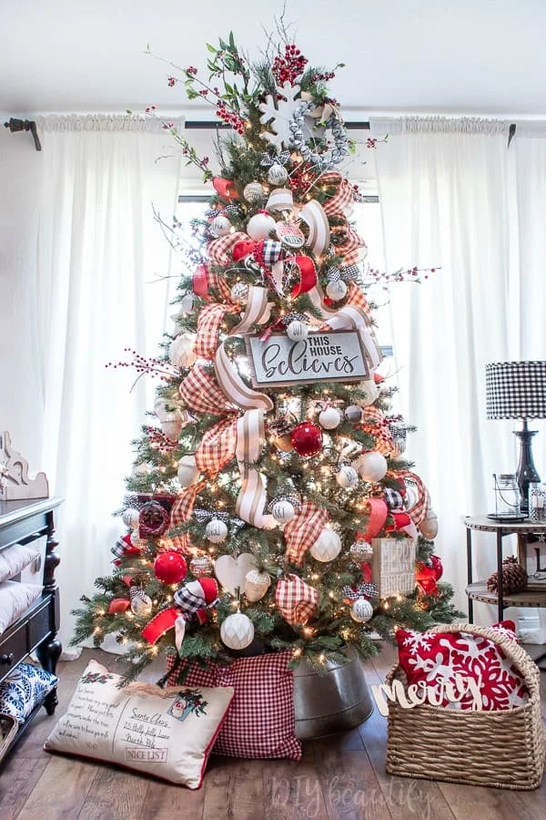 berries, large snowflake, jingle bell wreath used as Christmas tree topper