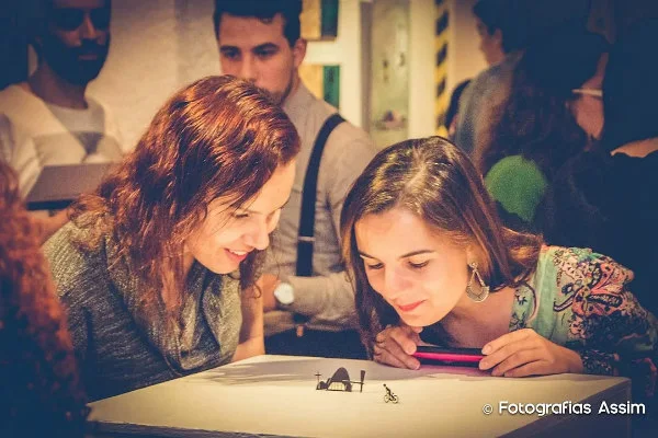 exhibit visitors get close look at black silhouette miniature paper cuttings