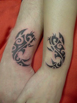free lovers tattoo as two fishes on the wrist