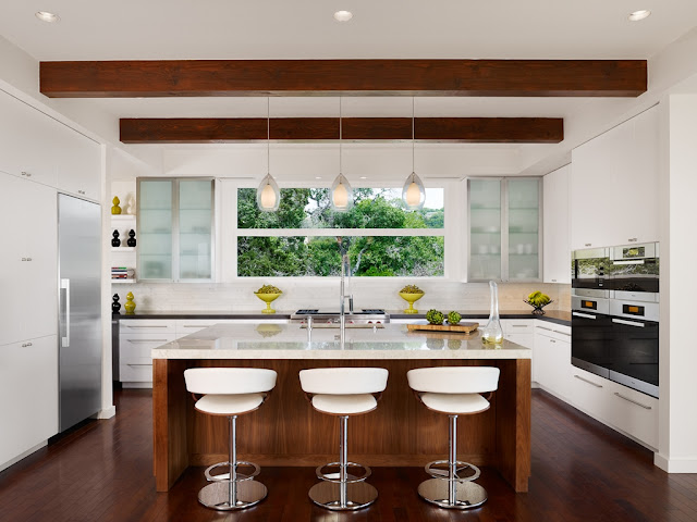 Photo of modern bright kitchen with kitchen island in the middle 