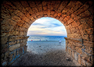 looking at the beach through a tunnel