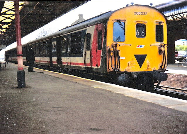 In a sad condition class 205032 diesel electric multiple unit uk passenger train in network south east livery stands in Basingstoke station 1988