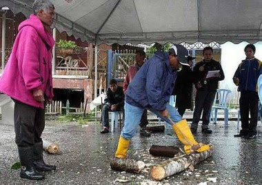 Effective way: A man chopping wood using a traditional hatchet during the competition