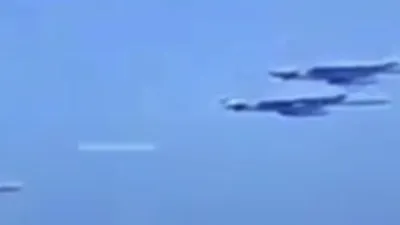White cylinder shape UFO nearly hits aircraft formation.