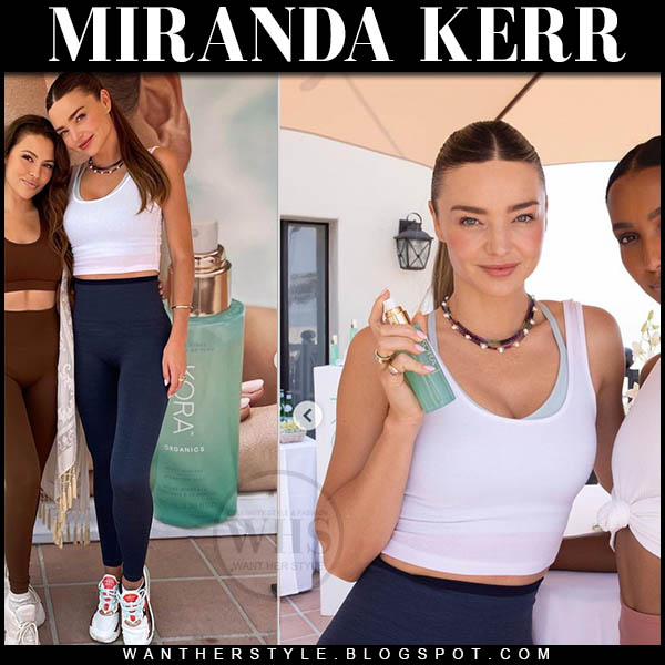 Miranda Kerr in white crop top, black leggings and sneakers