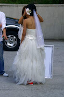 Second picture of the bride showing that her glowing orange shoes are visible even when she is not holding her dress up