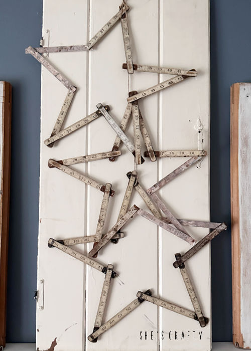 Vintage Rulers folded into stars hanging from cabinet door.