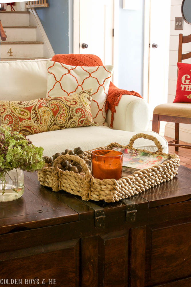 Pottery Barn beachcomber basket on coffee table in family room with white slipcovered Ikea sofa