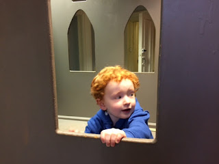 Toddler in an indoor play castle