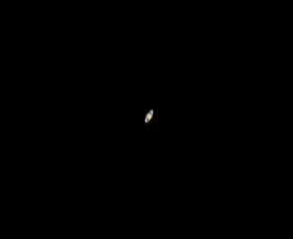 Saturn looks small at the eyepiece of a backyard telescope, stretched out like an olive as described by Galileo.