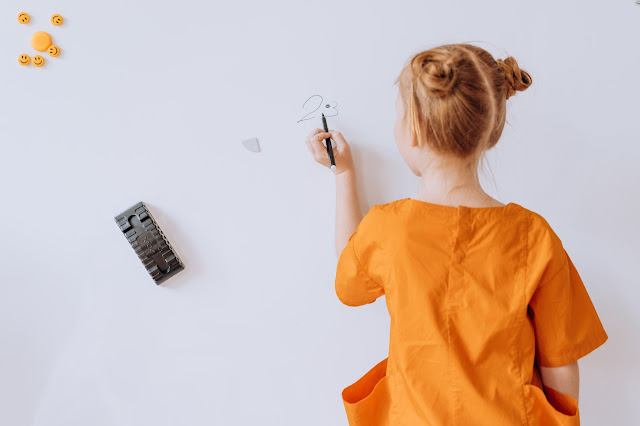 student using whiteboard for studying at home