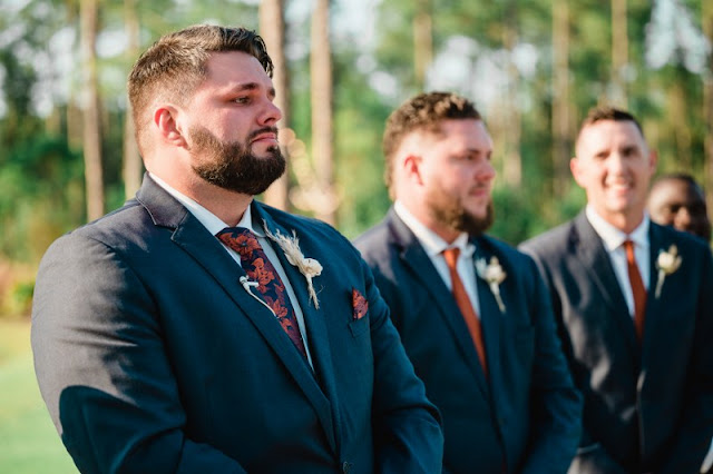 groom crying watching bride walking out