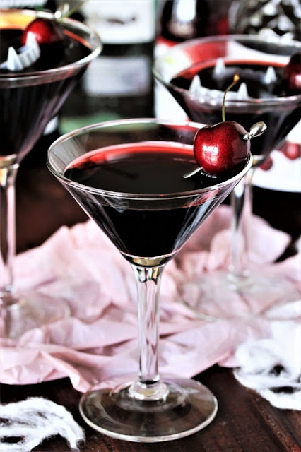 Dracula's Blood Cocktail with Fresh Cherry Garnish Image