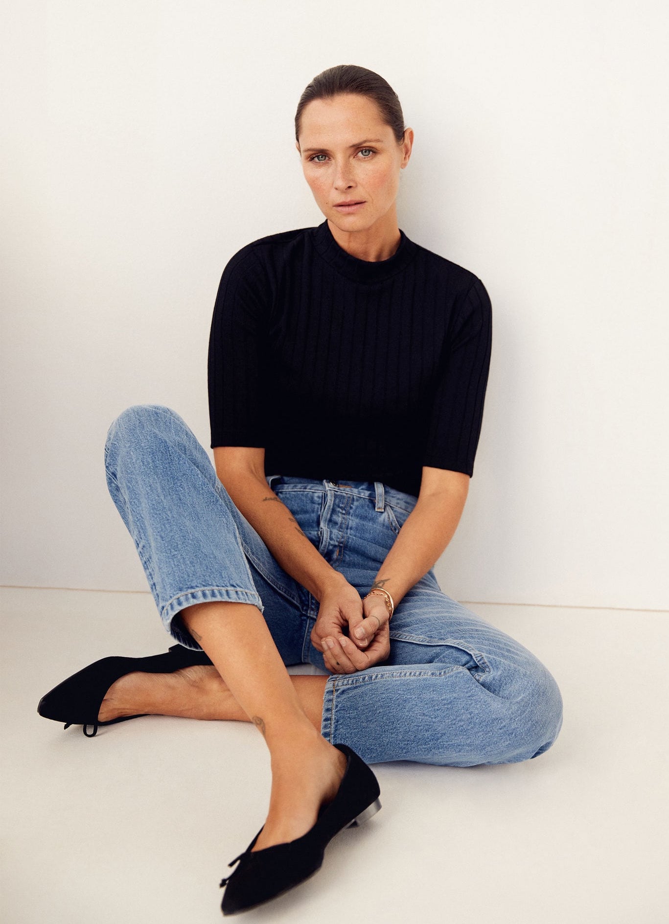 Classic casual chic outfit idea with short sleeve black turtleneck mock neck top, straight-leg jeans, black ballet flats — Tasha Tilberg for Mango