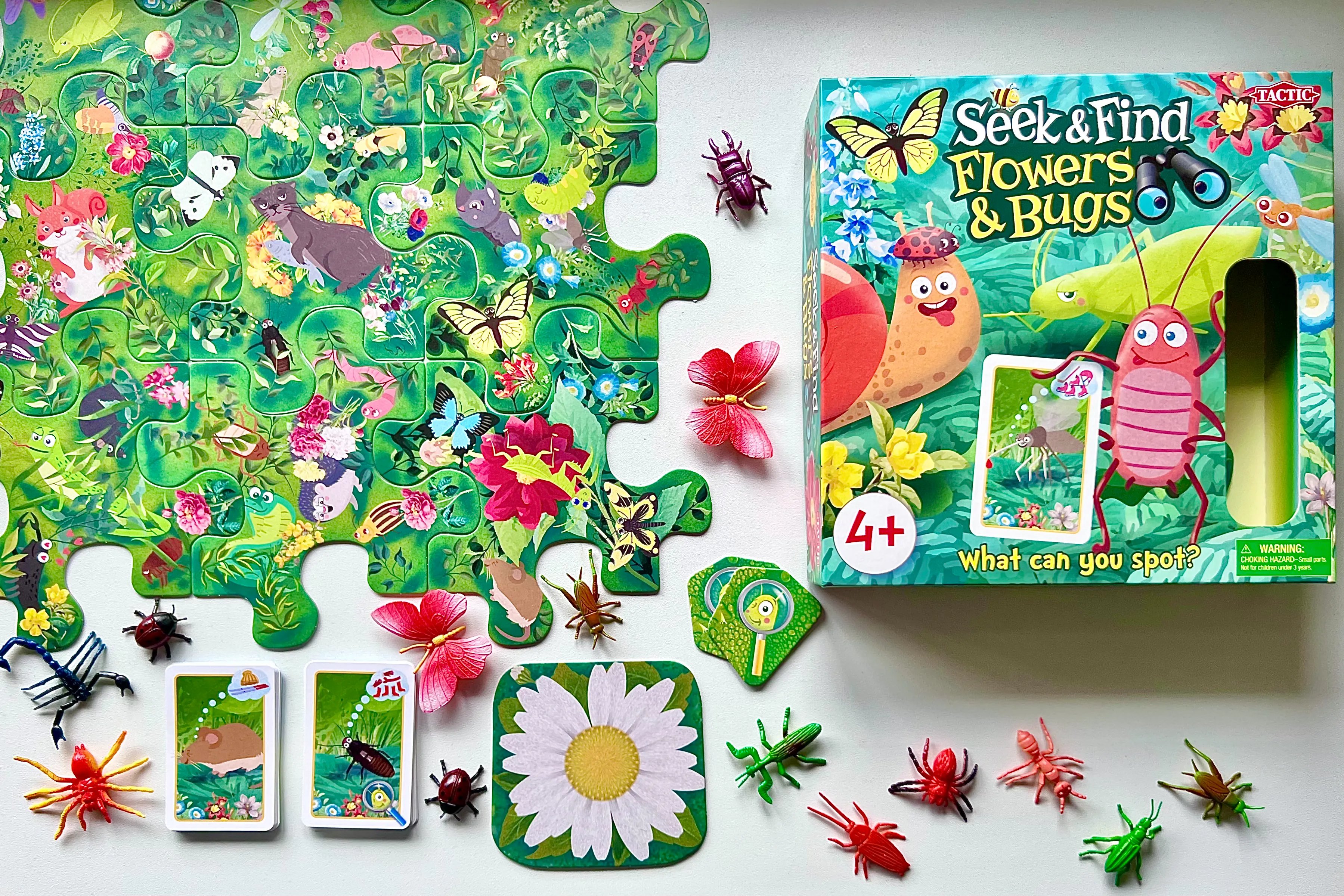 The Tactic Seek & Find game Flowers & Bugs version received to review and laid out on a table with the box