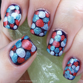Red, white, and blue textured blobbicure nail art in a purple creme base.