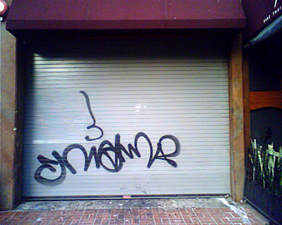 Mettle Rolling door with large spray painted graffiti.