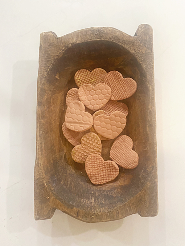 wooden bowl of clay hearts